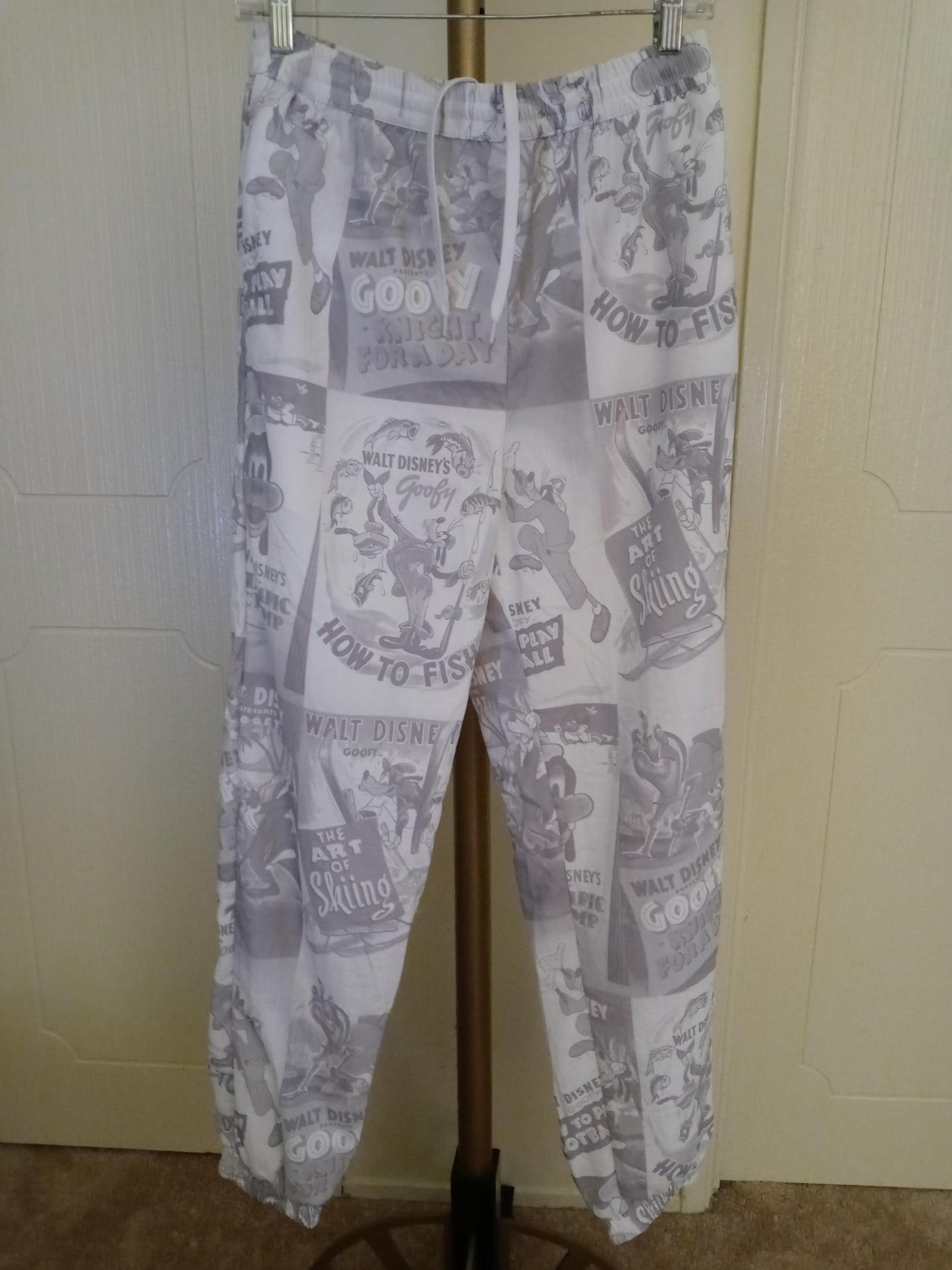 Disney D23 Expo 2022 Exclusive Goofy 90th Anniversary Track Pants Pre Owned - Good Condition Draw String Tie Up Front 2 Zipper Side Pockets 1 Zipper Back Pocket Unisex Size - Small Grey & White