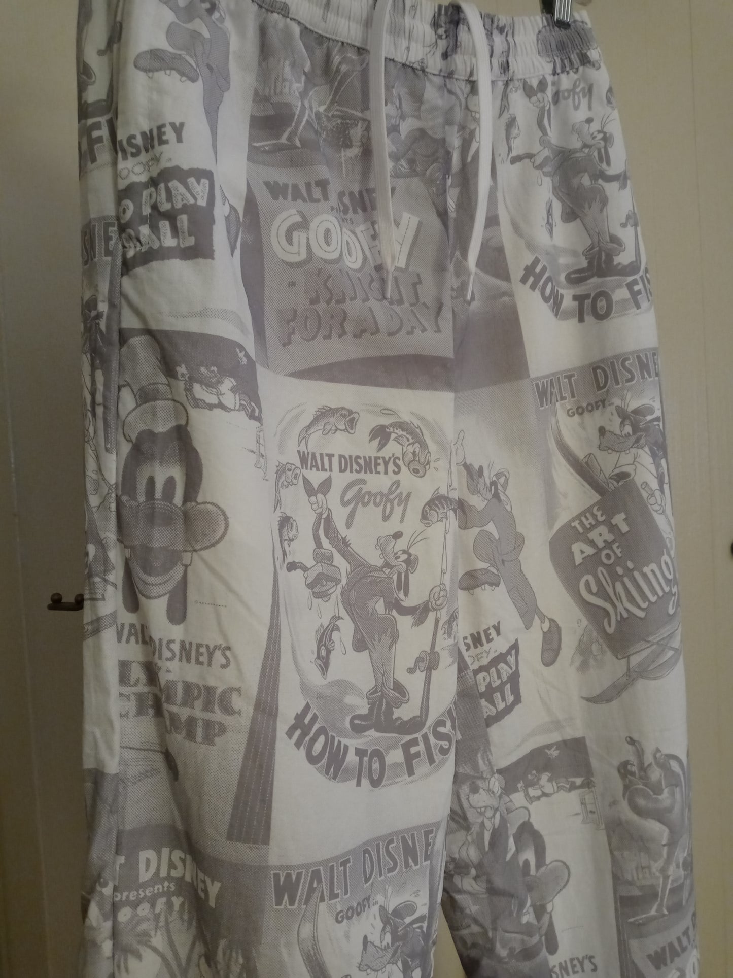 Disney D23 Expo 2022 Exclusive Goofy 90th Anniversary Track Pants Pre Owned - Good Condition Draw String Tie Up Front 2 Zipper Side Pockets 1 Zipper Back Pocket Unisex Size - Small Grey & White