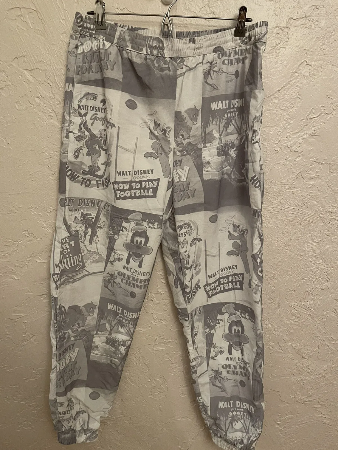 Disney D23 Expo 2022 Exclusive Goofy 90th Anniversary Track Pants Pre Owned - Good Condition Draw String Tie Up Front 2 Zipper Side Pockets 1 Zipper Back Pocket Unisex Size - Small Grey & White